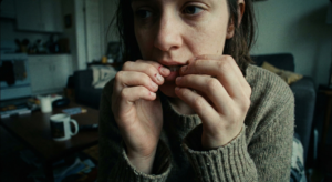 Close up of a woman biting her fingernails, a bad habit that damages the nail bed and increases infection risk.